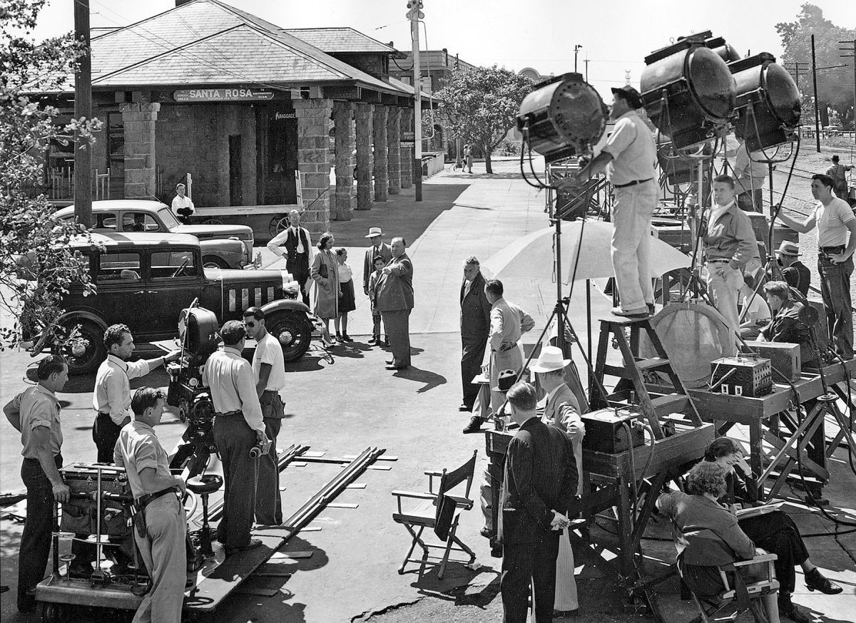 Hitchcock (center, pointing) and his production crew descended on the sleepy town of Santa Rosa, California, to shoot his thriller Shadow of a Doubt (1943), starring Teresa Wright and Joseph Cotten. Photographed by Joseph A. Valentine, ASC — who had previously shot Saboteur (1942) for Hitchcock — the picture was said to be the director’s favorite. He and Valentine (seen here behind the camera, holding a viewfinder) would later collaborate on Rope (1948).
